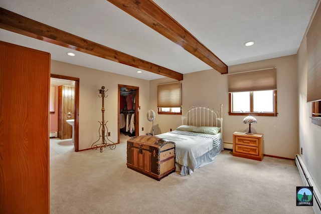 carpeted bedroom with baseboard heating, a spacious closet, and beamed ceiling