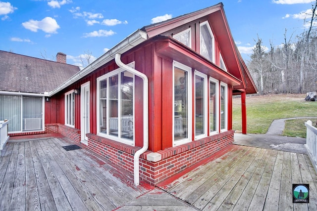 exterior space with a sunroom and a lawn