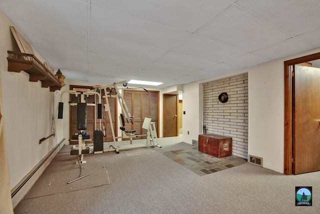 exercise room featuring carpet, a baseboard heating unit, and a drop ceiling