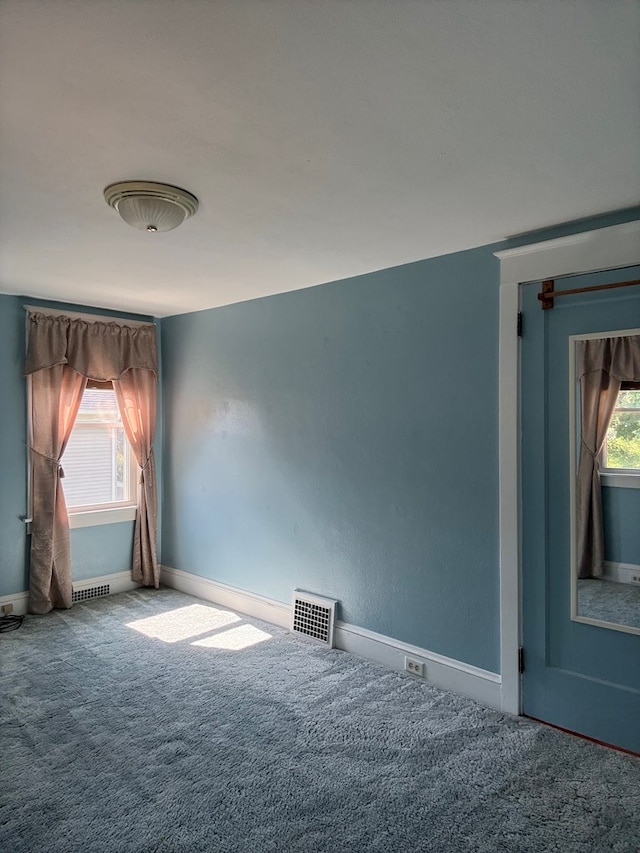 922 W Lockhart St, Sayre, PA 18840 - carpeted empty room with baseboards