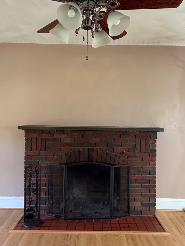 922 W Lockhart St, Sayre, PA 18840 - detailed view of a brick fireplace, ceiling fan, and wood finished floors