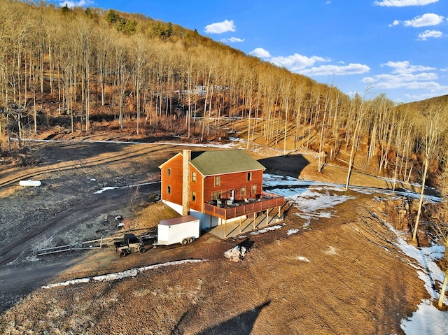 birds eye view of property with a forest view