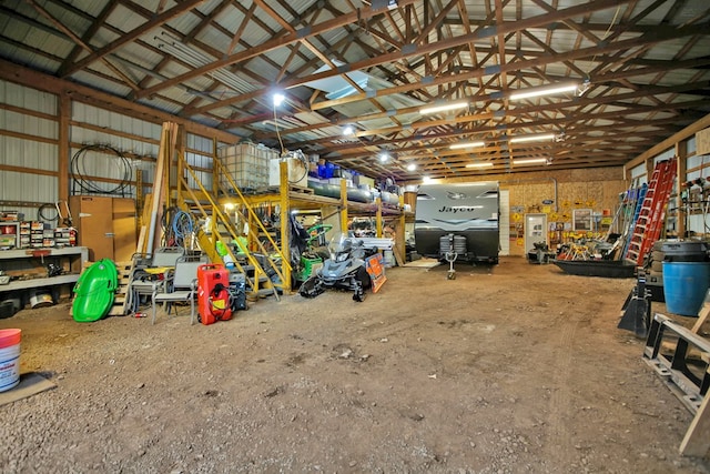 garage with a workshop area and metal wall