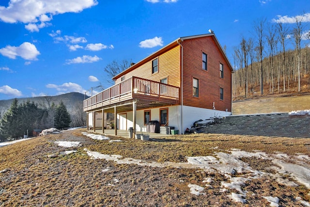 back of house featuring a deck with mountain view