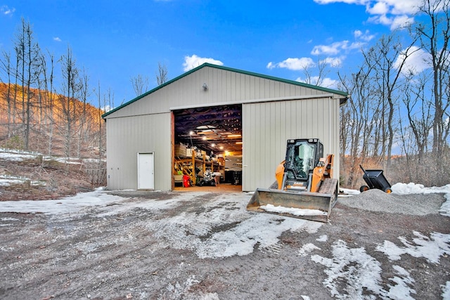 snow covered garage featuring a garage