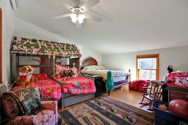 bedroom with lofted ceiling, ceiling fan, and wood finished floors