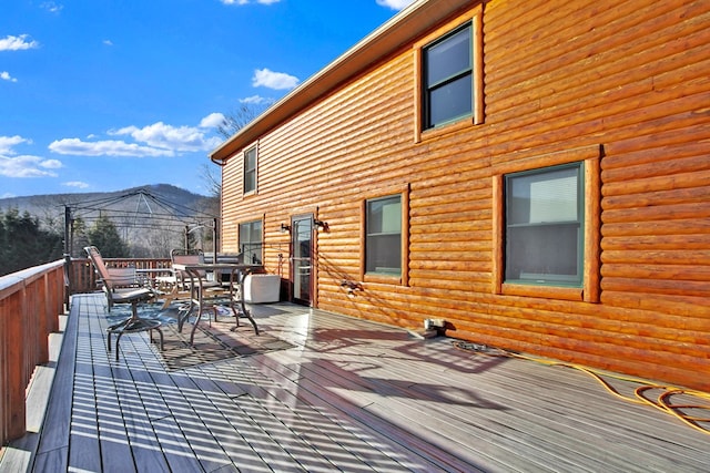 wooden terrace featuring outdoor dining area