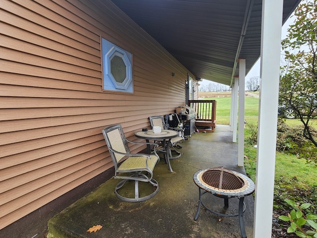 view of patio with a fire pit and a grill