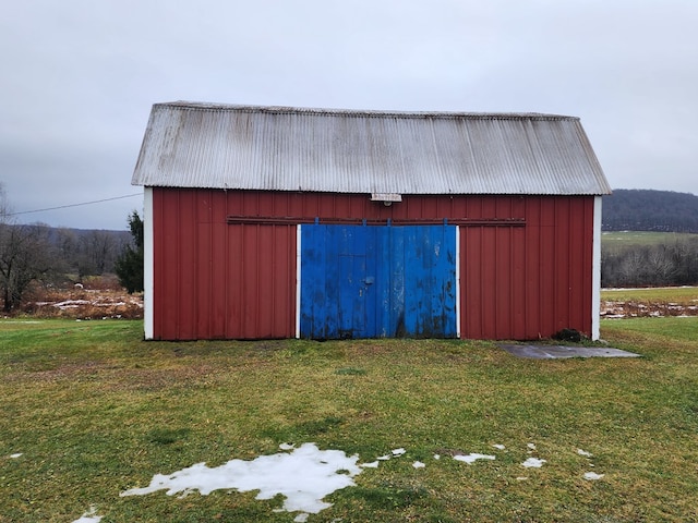 view of outbuilding with a lawn