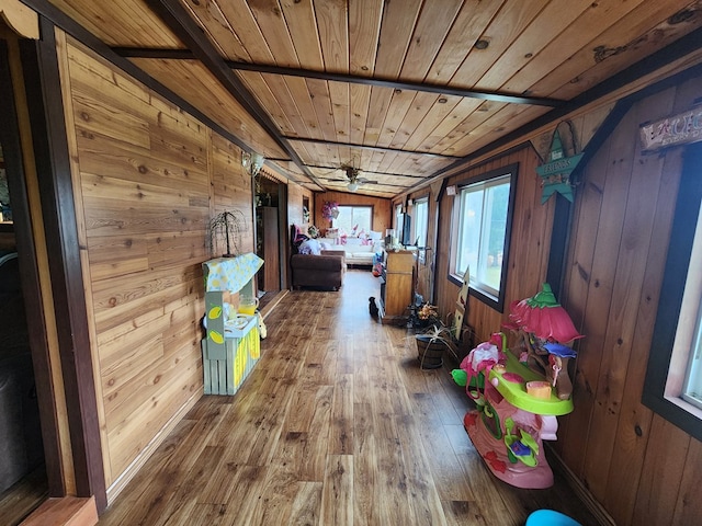 corridor with hardwood / wood-style flooring, wood walls, and wood ceiling