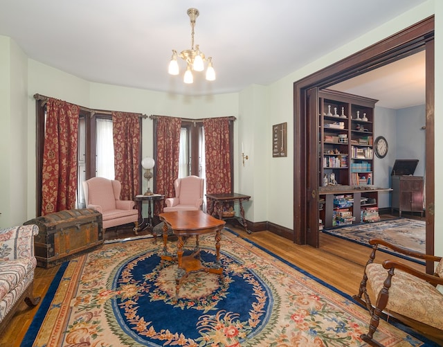 living room with hardwood / wood-style flooring and an inviting chandelier