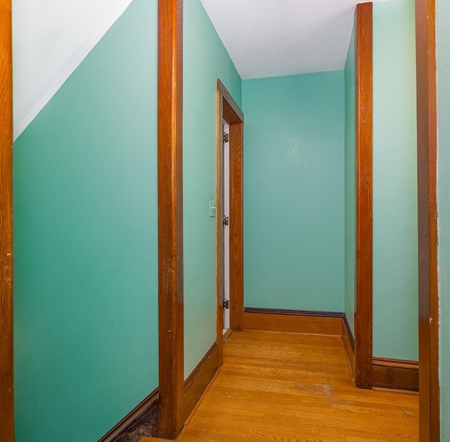 hallway with light hardwood / wood-style flooring