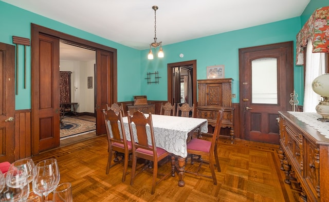 dining room with dark parquet flooring