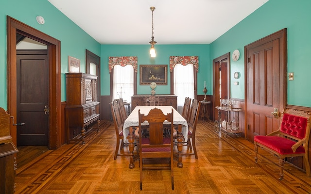 dining space with parquet floors