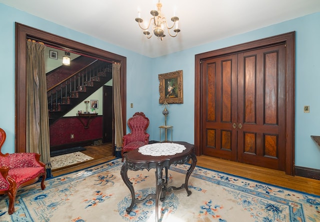 foyer with hardwood / wood-style floors and a notable chandelier