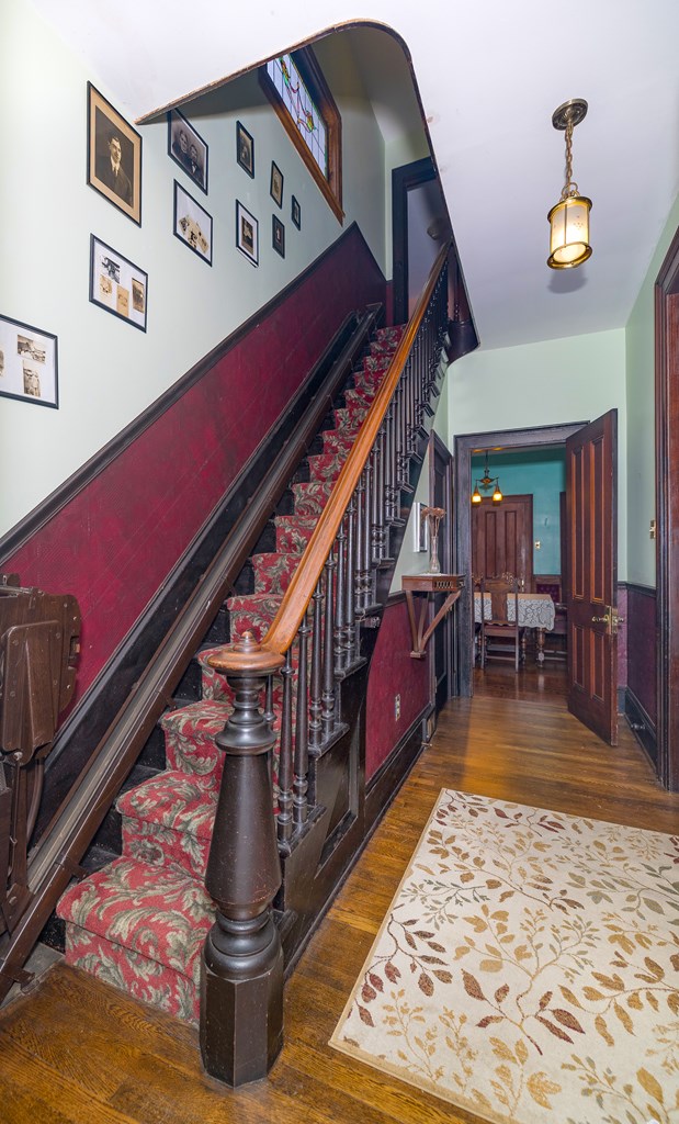 staircase with hardwood / wood-style floors