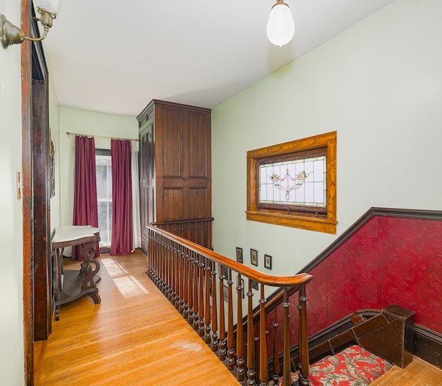 staircase with hardwood / wood-style floors