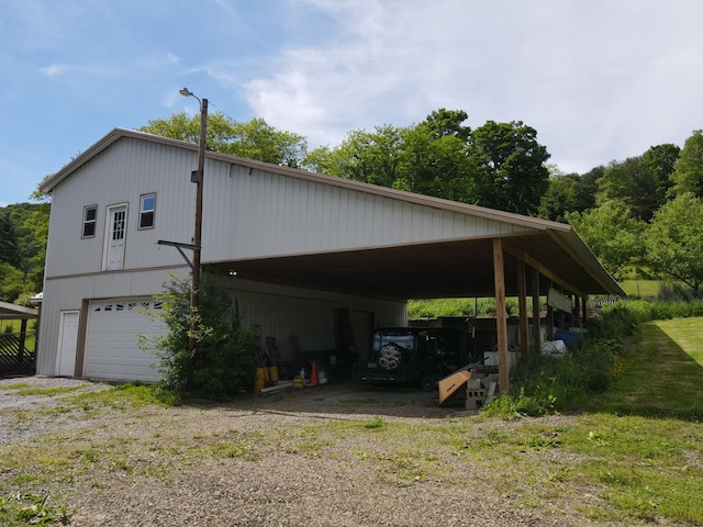 view of property exterior with a garage and a carport