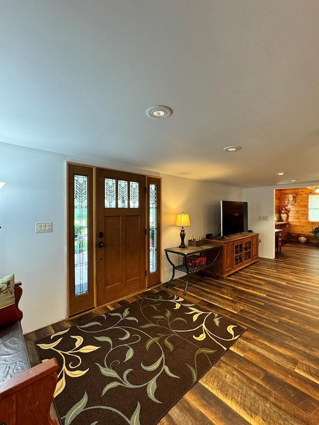 foyer featuring wood walls