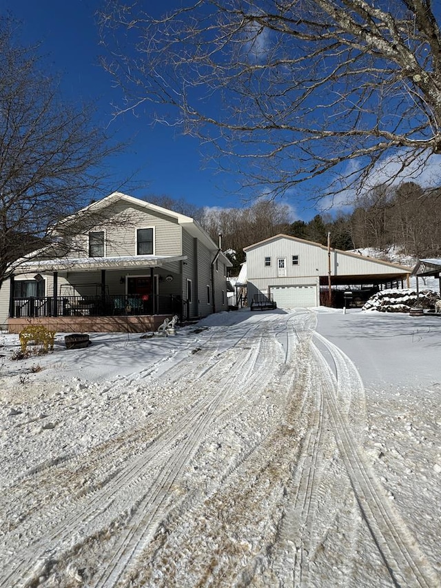 view of snowy exterior featuring a porch