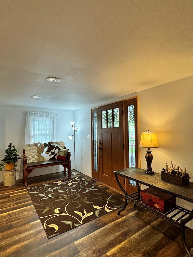 foyer featuring dark carpet