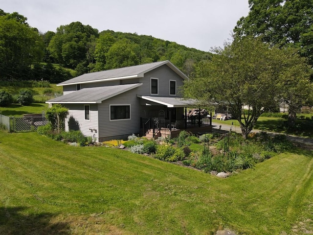 rear view of house featuring a lawn