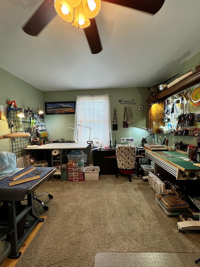 miscellaneous room with carpet flooring, a workshop area, and ceiling fan