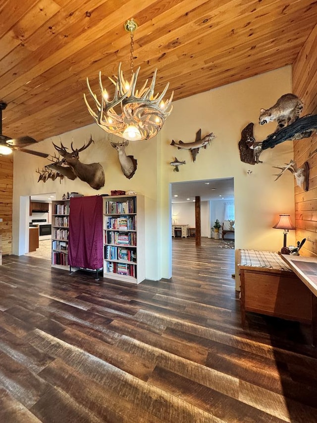 interior space with wooden ceiling, dark wood-type flooring, and wooden walls