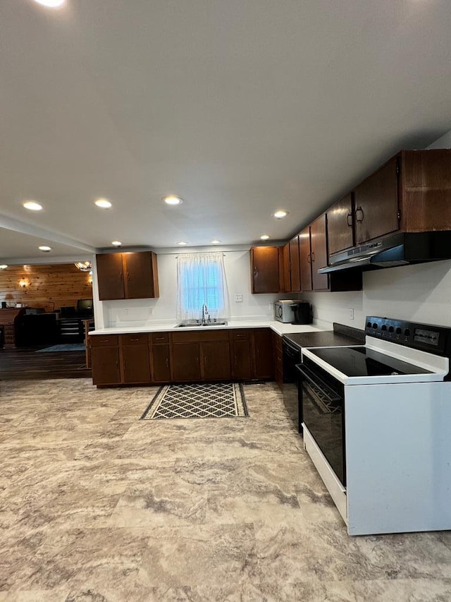 kitchen with dark brown cabinets, electric stove, and sink