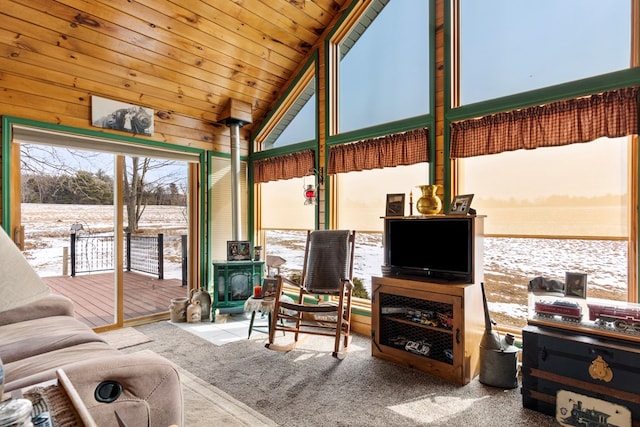 sunroom with vaulted ceiling, wooden ceiling, and a wood stove