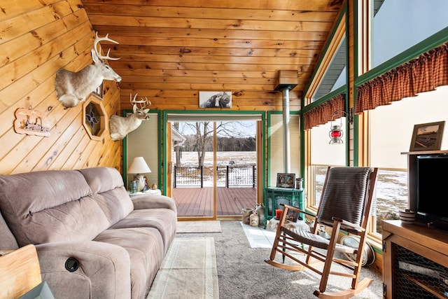 living area featuring a wood stove, carpet, wooden walls, and a towering ceiling