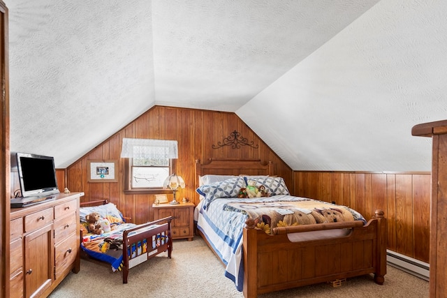 bedroom featuring light carpet, wood walls, a baseboard radiator, and a textured ceiling