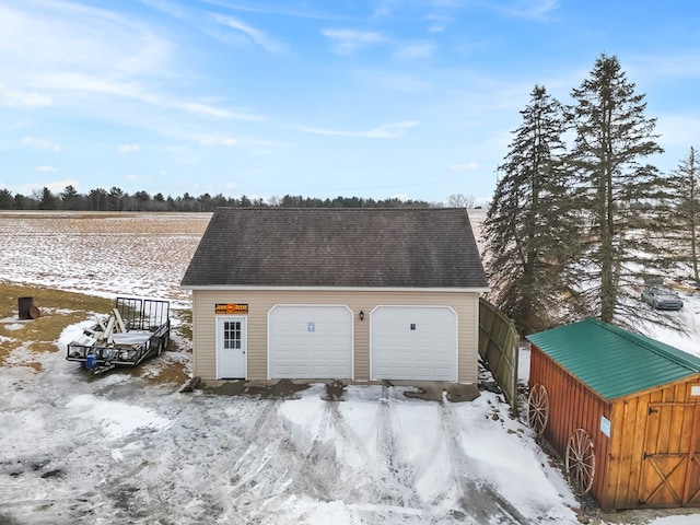 snow covered garage with a garage