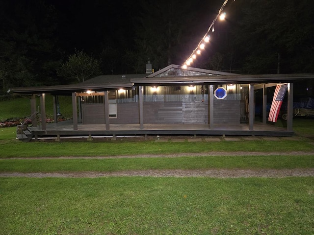 view of community featuring a wooden deck and a yard