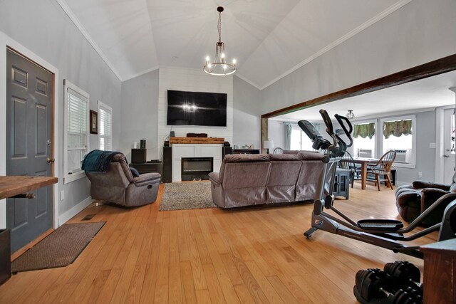 658 Ashley Hill Rd, Mansfield, PA 16933 - living area featuring crown molding, a chandelier, lofted ceiling, a fireplace, and light wood-style flooring