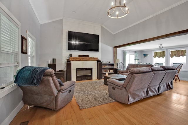 658 Ashley Hill Rd, Mansfield, PA 16933 - living area featuring lofted ceiling, ornamental molding, a chandelier, a large fireplace, and light wood finished floors