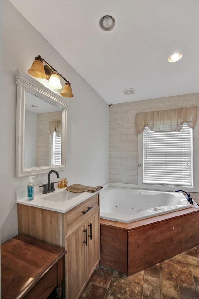658 Ashley Hill Rd, Mansfield, PA 16933 - full bathroom featuring vanity, a jetted tub, plenty of natural light, stone finish floors, and recessed lighting