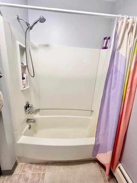 full bathroom with shower / tub combo, baseboard heating, and tile patterned floors