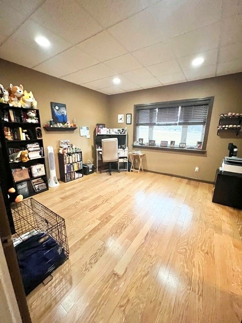 office area featuring a drop ceiling and wood finished floors