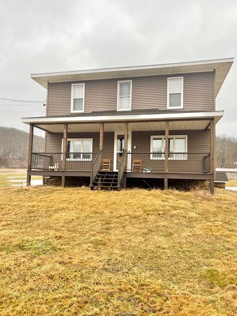 view of front of house featuring covered porch and a front yard