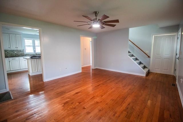 15 Loomis Ln, Gillett, PA 16925 - unfurnished living room with stairs, a ceiling fan, wood finished floors, and baseboards