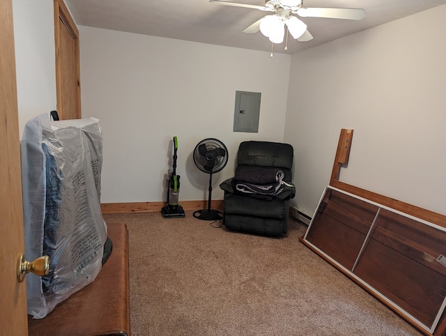 living area featuring carpet, electric panel, and ceiling fan