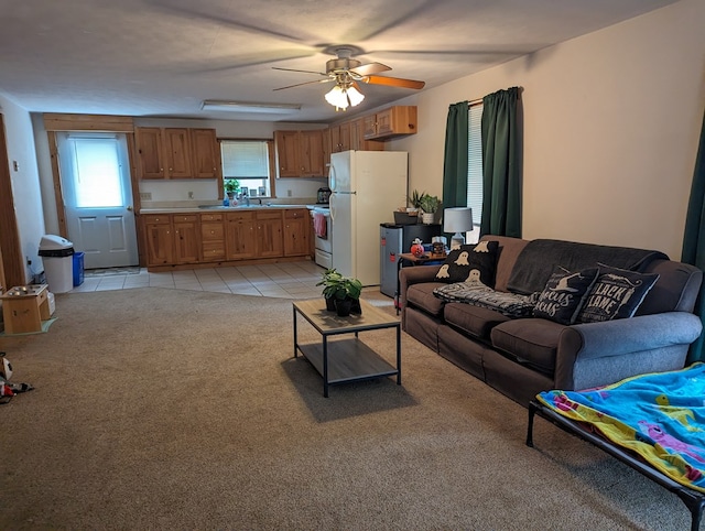 living room featuring light colored carpet, ceiling fan, and sink