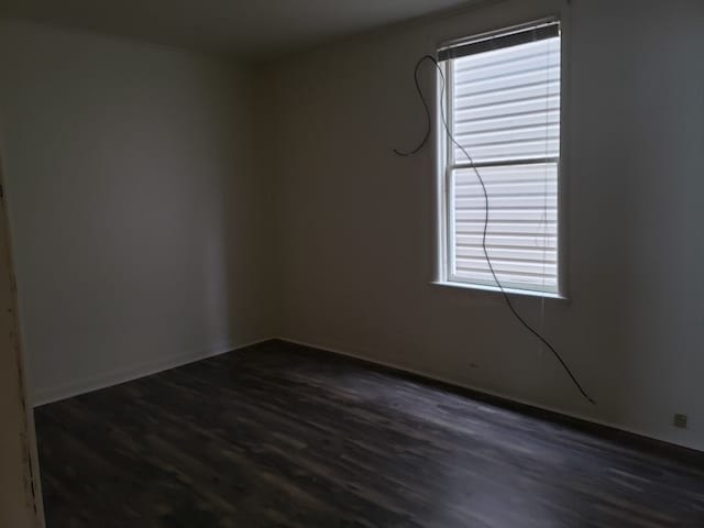 empty room with dark hardwood / wood-style floors