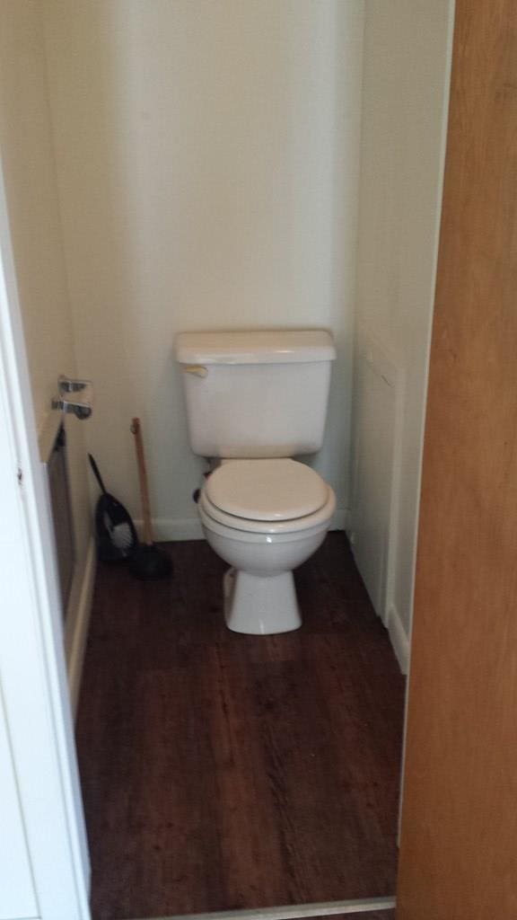 bathroom featuring hardwood / wood-style flooring and toilet