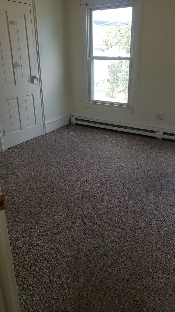 spare room with a baseboard radiator