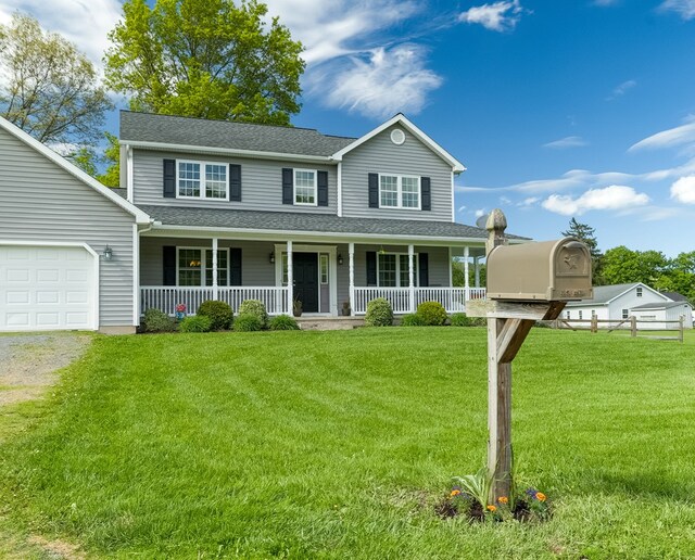 113 W Woodlawn Ave, Elkland, PA 16920 - view of front facade featuring covered porch, an attached garage, a front lawn, roof with shingles, and driveway