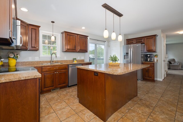 113 W Woodlawn Ave, Elkland, PA 16920 - kitchen featuring stainless steel appliances, a sink, a kitchen island, pendant lighting, and light stone countertops