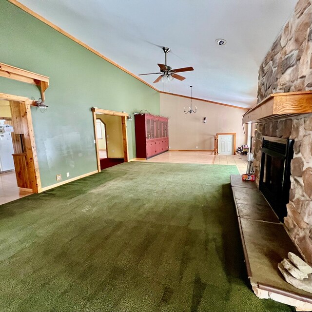 unfurnished living room with a fireplace, lofted ceiling, carpet flooring, and ceiling fan