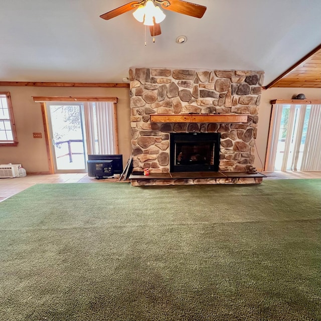 unfurnished living room with carpet floors, a healthy amount of sunlight, and a fireplace